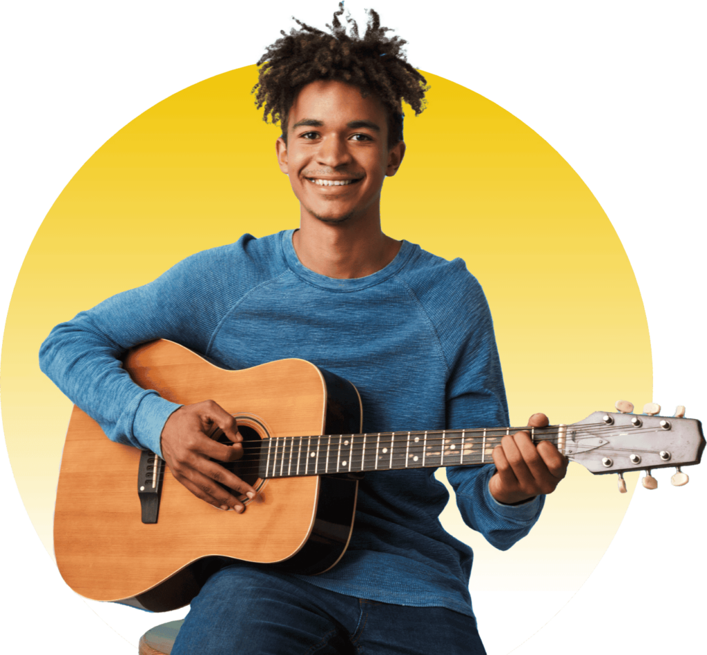 black teen smiling playing guitar